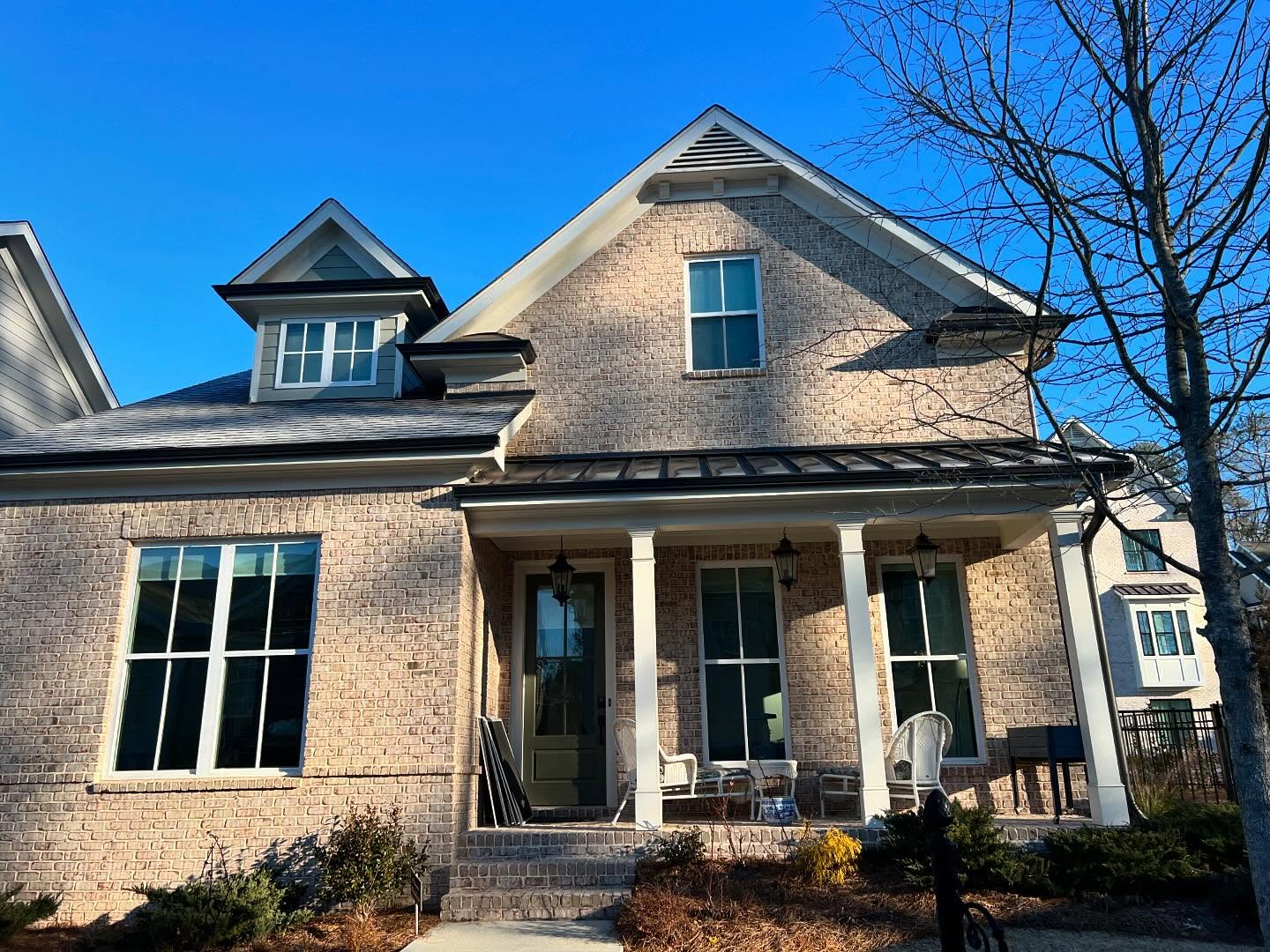 Brick home facade with clean windows on a sunny winter day