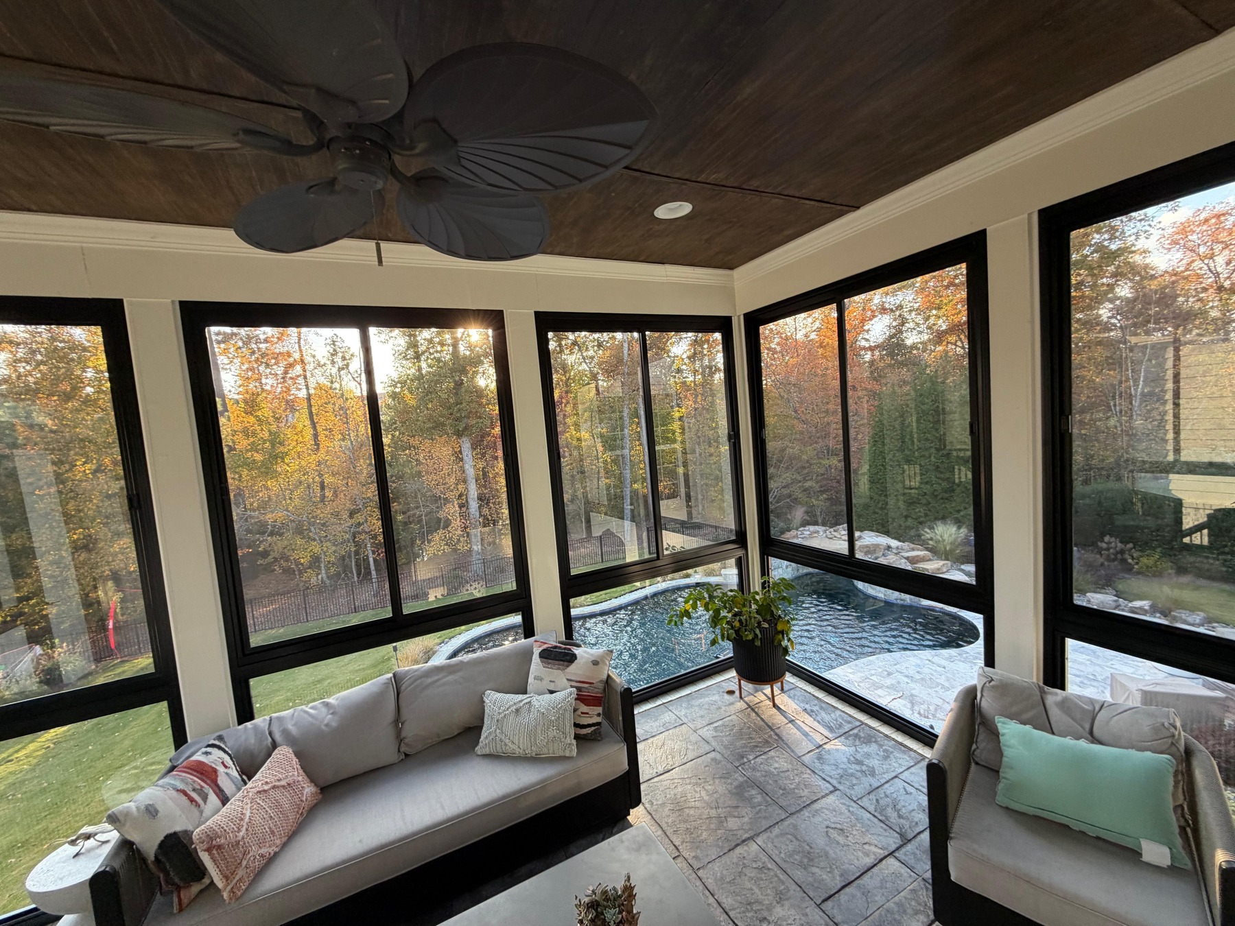 Bright sunroom with perfectly clean windows overlooking a pool